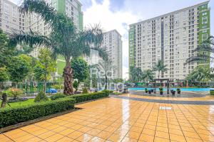 a street in a city with tall buildings at RedLiving Apartemen Kalibata City - Homy Jasen Tower Jasmine in Jakarta