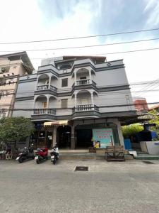 a building with motorcycles parked in front of it at 107 wanna Apartment pattaya in Pattaya Central