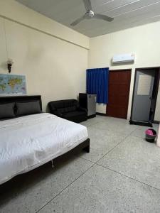a bedroom with a bed and a chair and a couch at Room101 in Wanna Apartment in Pattaya Central