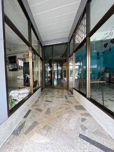 an empty building with glass doors and a tiled floor at Room101 in Wanna Apartment in Pattaya Central