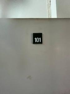 a black clock on the side of a building at Room101 in Wanna Apartment in Pattaya Central