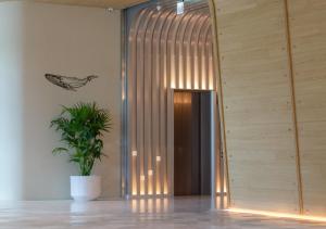 a hallway with a potted plant next to a door at The Archipelago in Toucheng