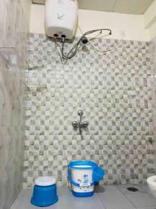 a bathroom with a toilet and a light on the wall at Lovely 2bed room AC apartment JP Nagar in Bangalore