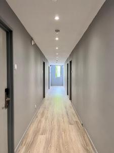 an empty hallway with a long corridor with wood floors at Bayu 23 Hotel in Kota Kinabalu