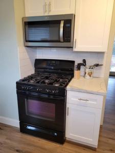a kitchen with a black stove and a microwave at Santa Rosa Gem in Santa Rosa