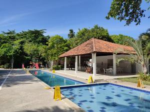 a swimming pool with a gazebo and a resort at AP Maria Farinha in Paulista