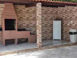 a brick wall with a refrigerator on a patio at AP Maria Farinha in Paulista