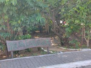 a sign that says raila lodgevelt in front of trees at AP Maria Farinha in Paulista
