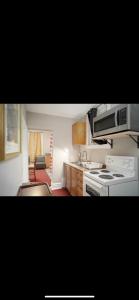 a kitchen with a stove and a microwave at Room #3 Ottawa downtown in Ottawa