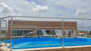 a swimming pool on the roof of a building at Flat JOÃO PESSOA JACUMÃ in Jacumã