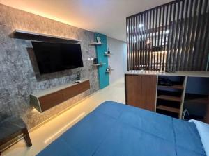 a bedroom with a bed and a tv on a wall at Dpto lujoso, comodo e intimo cerca de todo in Santa Cruz de la Sierra +9 photos