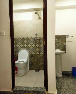a bathroom with a toilet and a sink at Nirvana Kuti in Kathmandu