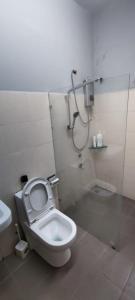 uma casa de banho com um WC e um chuveiro em TAR HOMESTAY em Lahad Datu