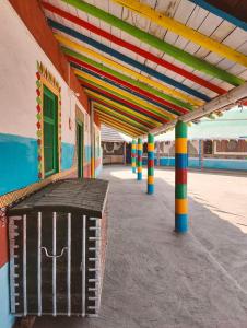 a colorful building with a trash can under a roof at Rann bhumi village resort in Bherandiāla