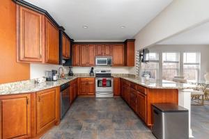 a large kitchen with wooden cabinets and appliances at Scenic Skyline View-Downtown in Cincinnati