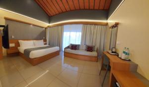 Katil atau katil-katil dalam bilik di Upavan Resort