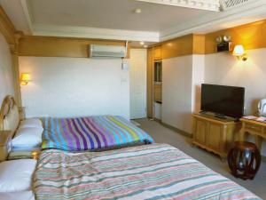 Postel nebo postele na pokoji v ubytování New Daxi B&B