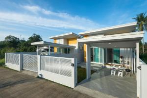 a modern house with a deck with a patio at The Haven Krabi in Ao Nang Beach
