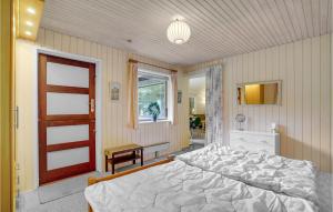 een slaapkamer met een bed, een raam en een deur bij Awesome Home In Vggerlse With Kitchen in Bøtø By