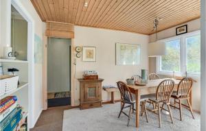a dining room with a table and chairs at Awesome Home In Fårevejle With Kitchen in Fårevejle