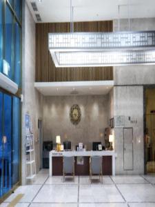 a lobby with a desk and chairs in a building at Rosana Hotel in Seoul