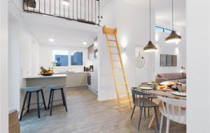 a kitchen and living room with a ladder and a table and chairs at Cozy Home In Lembruchdümmer See in Lembruch