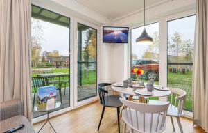 a dining room with a table and chairs at Beach Front Apartment In Lembruch-dmmer See With Kitchenette in Lembruch