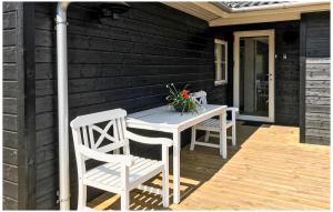a white table and chairs on a wooden deck at 3 Bedroom Awesome Home In Hasle in Hasle +11 photos