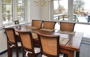 a dining room with a wooden table and chairs at Nice Home In Skrbk With Kitchen in Vestergård