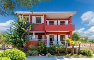 una casa rossa con alberi di fronte di Nice Apartment In Barbat With 2 Bedrooms And Wifi a Barbat na Rabu