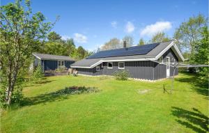 a house with a solar roof on a yard at 3 Bedroom Awesome Home In Middelfart in Middelfart