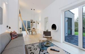 a living room with a couch and a table at Beach Front Home In Lembruchdümmer See in Lembruch +32 photos