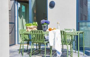 a table and chairs on a patio at Beach Front Home In Lembruchdümmer See in Lembruch +40 photos
