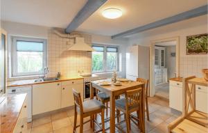 a kitchen with a table and chairs and a sink at 2 Bedroom Stunning Home In Lehe in Lehe