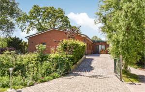 a brick building with a gate and a brick walkway at 2 Bedroom Stunning Home In Lehe in Lehe