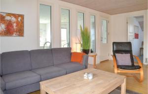 a living room with a couch and a chair at Pet Friendly Home In Henne With Sauna in Henne Strand