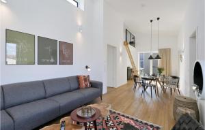 a living room with a couch and a table at Amazing Home In Lembruch-dmmer See With Sauna in Lembruch