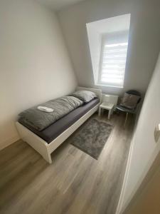 Habitación pequeña con cama y ventana en Apartment / Wohnung / NETFLEX/Prime, en Krefeld
