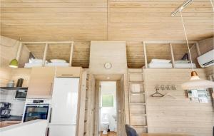 a tiny house with wooden walls and a kitchen at Lovely Home In Knebel With Sauna in Skødshoved Strand +27 photos