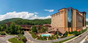 a hotel with a pool in front of a building at Harrah's Cherokee Casino Resort in Cherokee