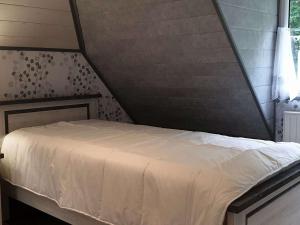 a bedroom with a bed in a attic at Maison Saint-Quay-Perros, 4 pièces, 6 personnes - FR-1-368-258 in Saint-Quay-Perros