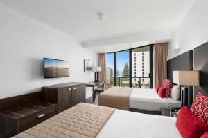 a hotel room with two beds and a balcony at Hotel Deluxe Twin at Legends - Q Stay in Gold Coast