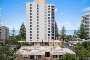 an apartment building in front of a tall white building at Hotel Deluxe Twin at Legends - Q Stay in Gold Coast