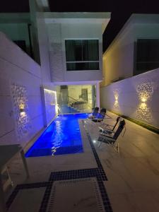a swimming pool in the middle of a house at Boa Beach House in Porto Seguro