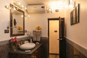 a bathroom with a sink and a mirror at Heritage View in Ooty