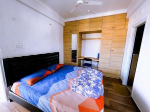 a bedroom with a large bed and wooden cabinets at RVR Abode -Private Rooms in Bangalore