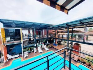 a balcony with a swimming pool on a building at Retro Box Hotel Chumphon in Chumphon