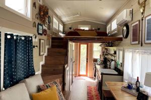 a tiny house with a kitchen and a loft at TaHOW in Huntsville