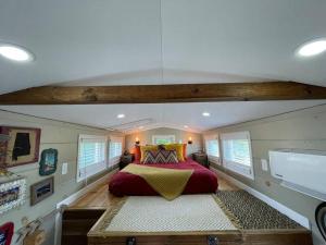 a bedroom with a large red bed in a room at TaHOW in Huntsville