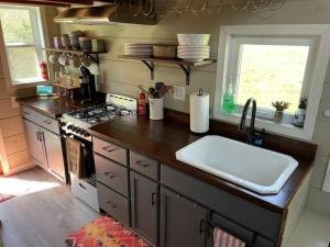 a kitchen with a counter with a sink and a stove at TaHOW in Huntsville